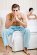 Young married couple quarrels in bed-room