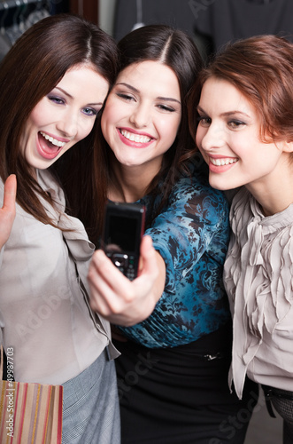 Photo: Three pretty girls take photo after shopping at the mall Three pretty girls take photo after shopping at the mall