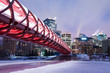 Calgary skyline and pedestrian bridge at night.