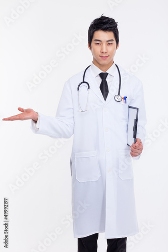Photo: Young Asian doctor present something. Young Asian doctor present something.