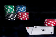 Photo: two aces high on black table with chips two aces high on black table with chips