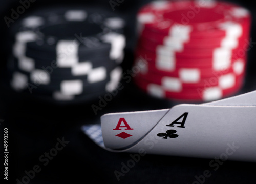 Photo: two aces high on black table with chips two aces high on black table with chips
