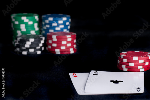 Photo: two aces high on black table with chips two aces high on black table with chips
