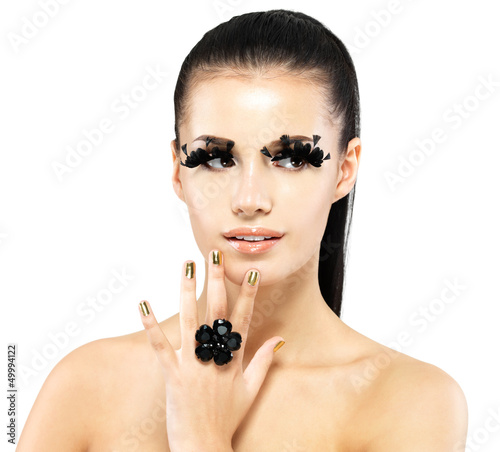 Photo: Woman with golden nails and style makeup Woman with golden nails and style makeup