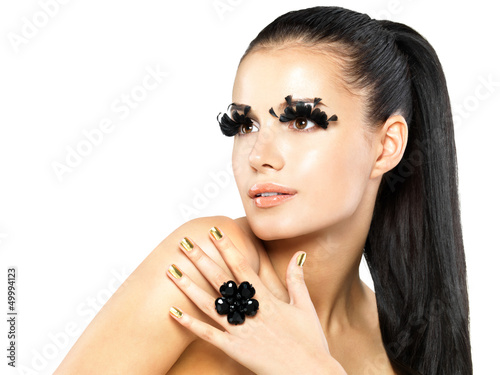 Photo: Woman with golden nails and style makeup Woman with golden nails and style makeup