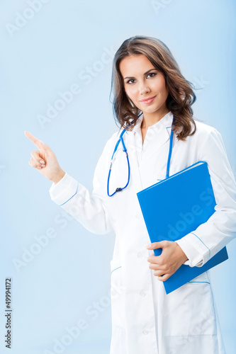Photo: Showing doctor with folder, over blue Showing doctor with folder, over blue