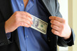Man in a putting money in his pocket
