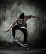 Young man in hat and shirt performing stunt on skateboard