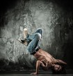 Young b-boy man with naked torso doing brake dancing movements