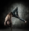 Young b-boy man with naked torso doing brake dancing movements