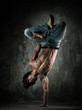 Photo: Young b-boy man with naked torso doing brake dancing movements Young b-boy man with naked torso doing brake dancing movements