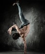 Photo: Young b-boy man with naked torso doing brake dancing movements Young b-boy man with naked torso doing brake dancing movements