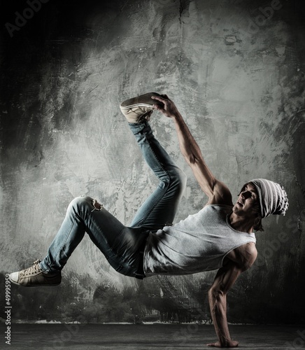 Photo: Young b-boy man doing brake dancing movements Young b-boy man doing brake dancing movements