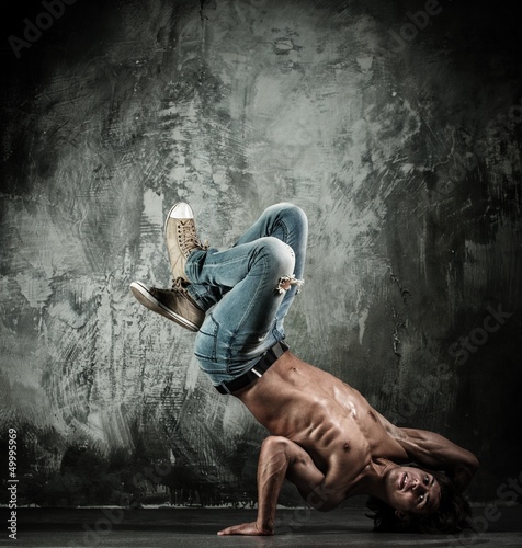 Photo: Young b-boy man with naked torso doing brake dancing movements Young b-boy man with naked torso doing brake dancing movements