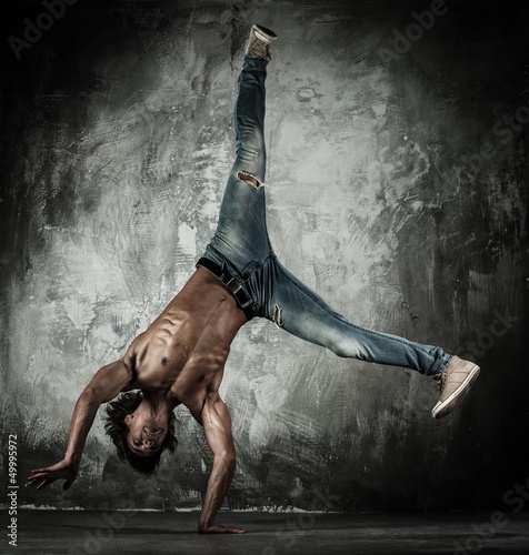 Photo: Young b-boy man with naked torso doing brake dancing movements Young b-boy man with naked torso doing brake dancing movements