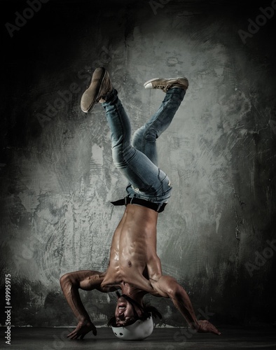 Photo: Young b-boy man with naked torso doing brake dancing movements Young b-boy man with naked torso doing brake dancing movements