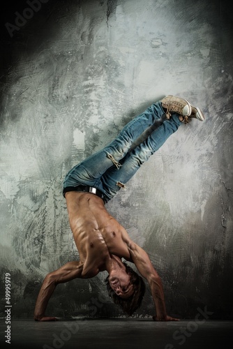 Photo: Young b-boy man with naked torso doing brake dancing movements Young b-boy man with naked torso doing brake dancing movements