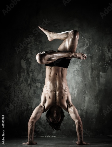 Photo: Young b-boy man with naked torso doing brake dancing movements Young b-boy man with naked torso doing brake dancing movements