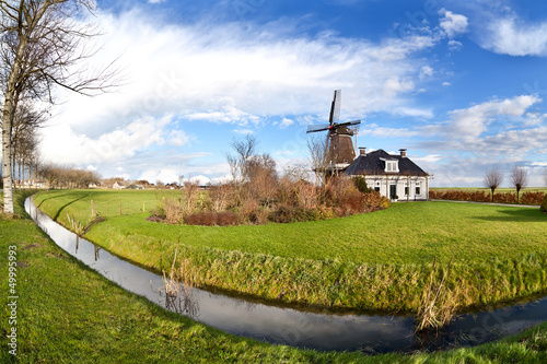 Photo: Dutch windmill over blue sky Dutch windmill over blue sky