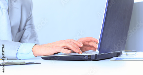 Photo: The businessman at the age of works for the laptop. The businessman at the age of works for the laptop.