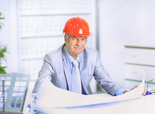 Photo: Engineer at the age of considering plans Engineer at the age of considering plans