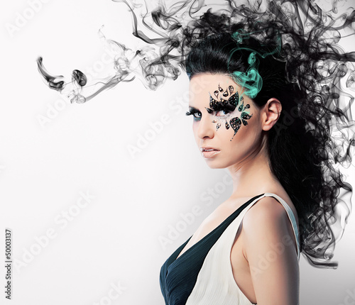 Photo: face art of rhinestones on brunette woman and smoke face art of rhinestones on brunette woman and smoke