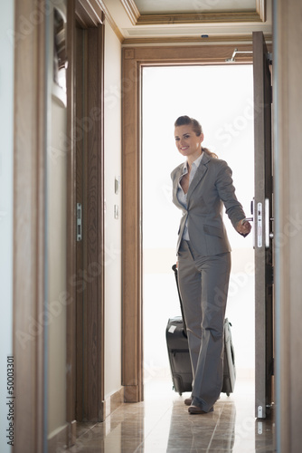 Photo: Business woman entering hotel room Business woman entering hotel room