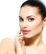 Beautiful Young Woman with Fresh Clean Skin touching her Face