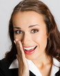Businesswoman covering mouth, over gray
