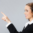 Businesswoman showing, on gray
