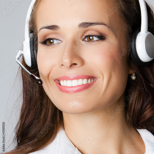 Photo: Support phone operator pointing, over gray Support phone operator pointing, over gray