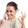 Foto : Businesswoman with phone showing okay sign Businesswoman with phone showing okay sign