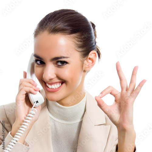 Photo: Businesswoman with phone showing okay sign Businesswoman with phone showing okay sign