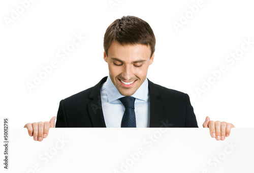 Photo: Businessman showing blank signboard, isolated Businessman showing blank signboard, isolated