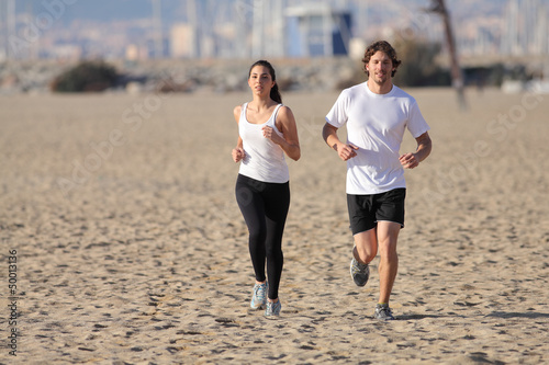Photo: Man and woman running on the beach Man and woman running on the beach