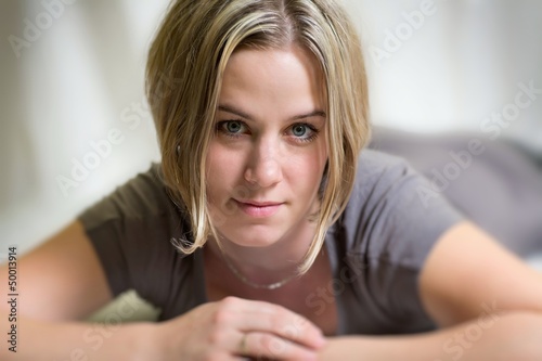 Photo: Beautiful woman lying on a bed Beautiful woman lying on a bed