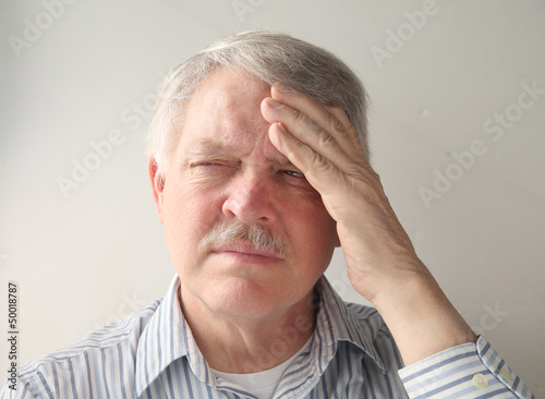Photo: senior man has a bad headache senior man has a bad headache
