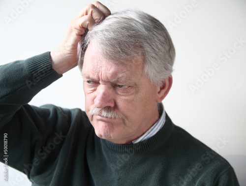 Photo: senior man with frustrated expression senior man with frustrated expression