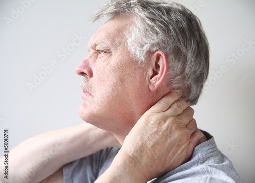 Photo: man with pain in neck man with pain in neck