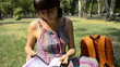 Video: young pregnant woman sitting on the grass with a phone young pregnant woman sitting on the grass with a phone