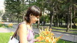 young pregnant woman sniffing flowers