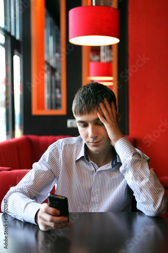 Photo: Sad Young Man With Phone Sad Young Man With Phone