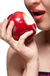 Photo: Young woman biting red apple isolated on white Young woman biting red apple isolated on white