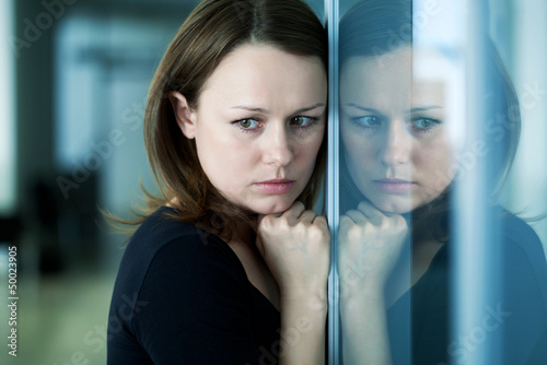 Photo: sad woman at the window sad woman at the window