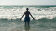 Young man standing in the sea, slow motion shot at 480fps