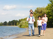 Happy young family with children outdoor near the river