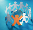 Paper people standing in a circle around glass