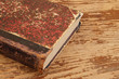 Old book isolated on wooden background