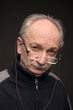 An elderly man with glasses