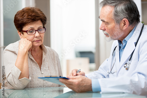 Photo: Patient tells the doctor about her health complaints Patient tells the doctor about her health complaints
